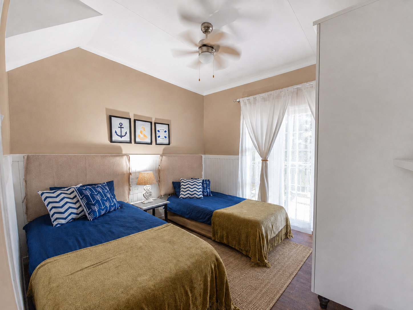 Twin bedroom with rattan bedside lamp and natural woven rug